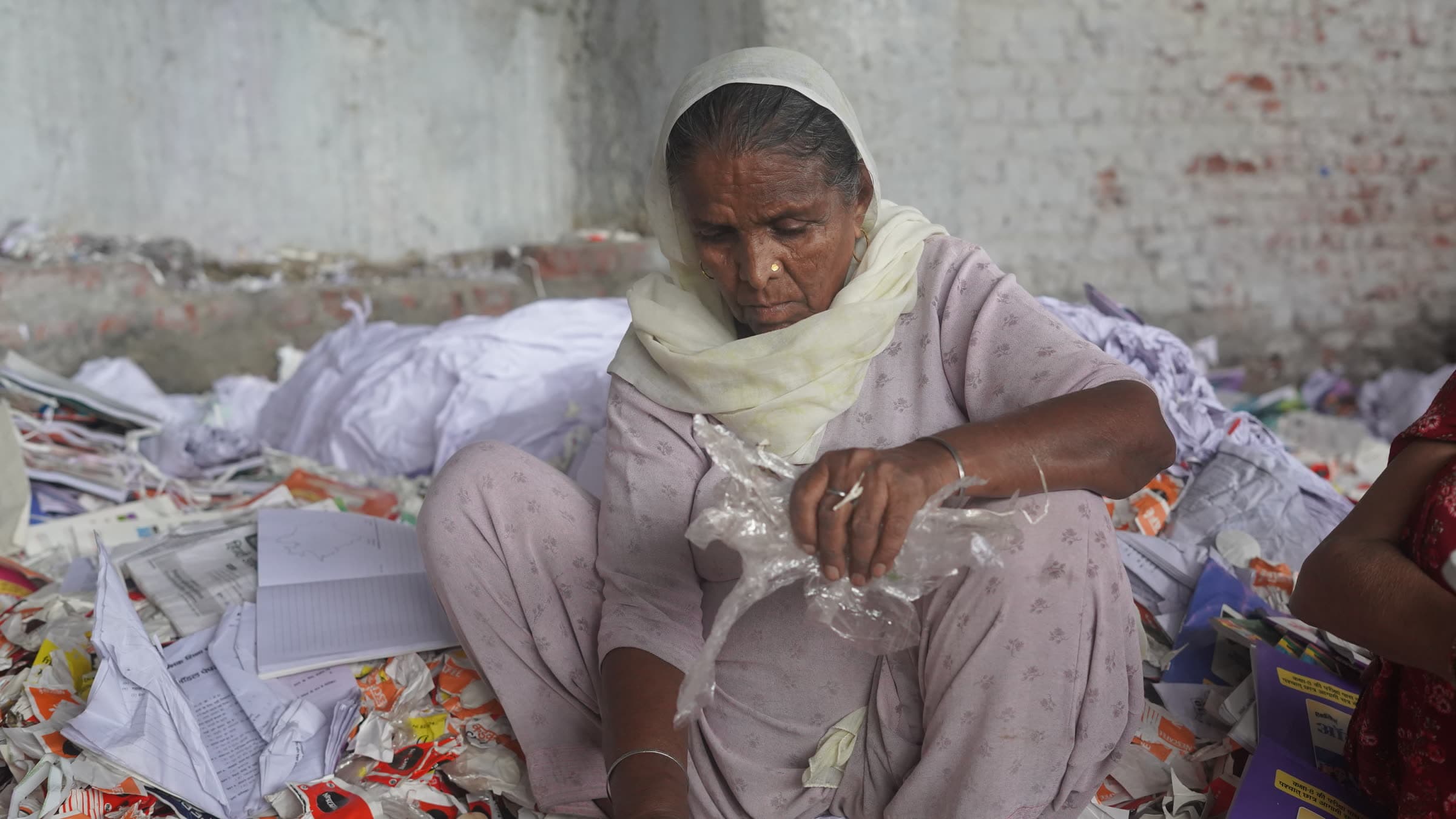 A sorter pulling contaminants out of recovered paper by hand